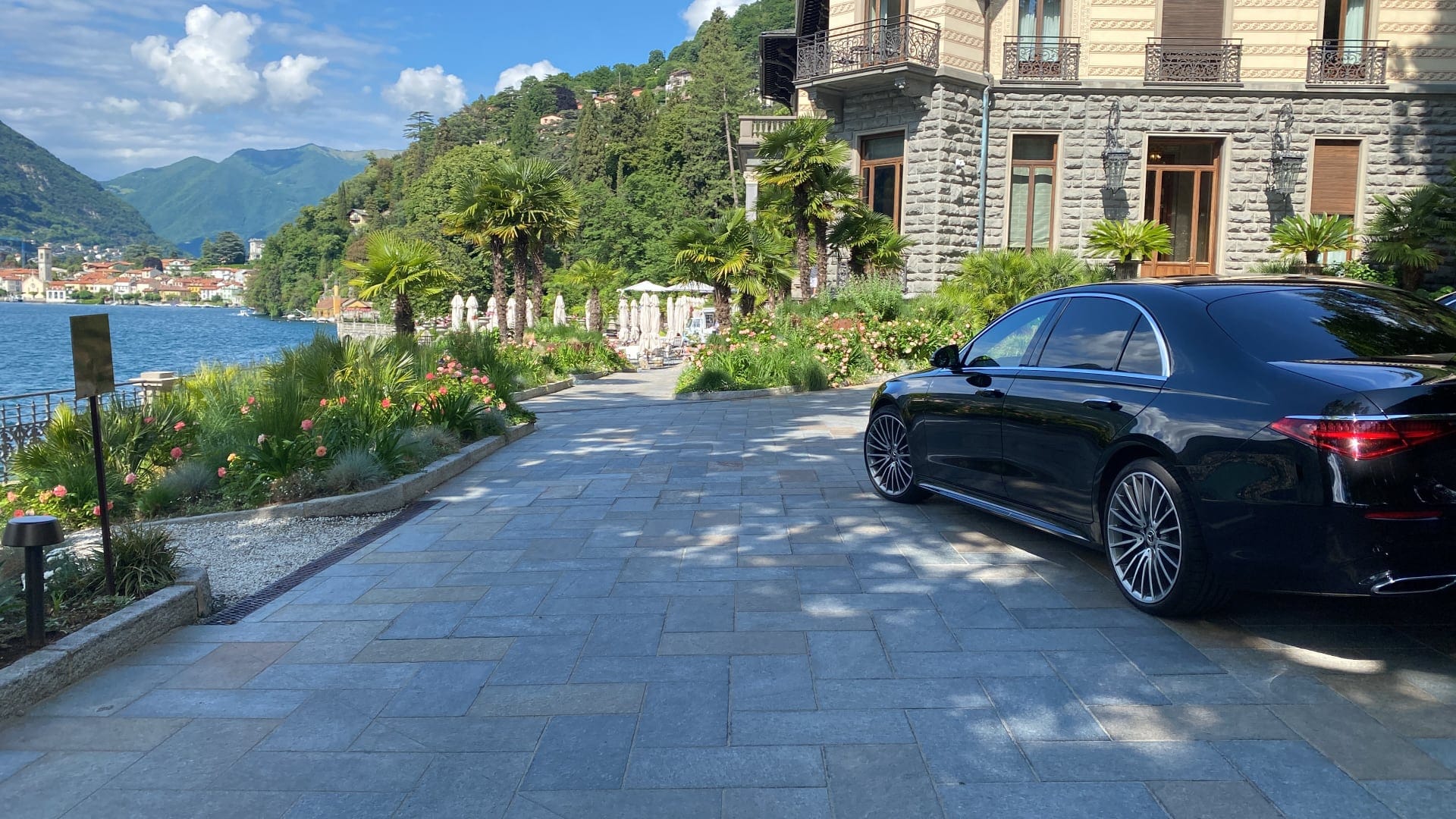 photo of a black Mercedes car parked in a villa courtyard